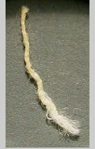 Yellow dye seen from spliced thread. Newer material was dyed with alizarin from madder root to match age-yellowed older thread.